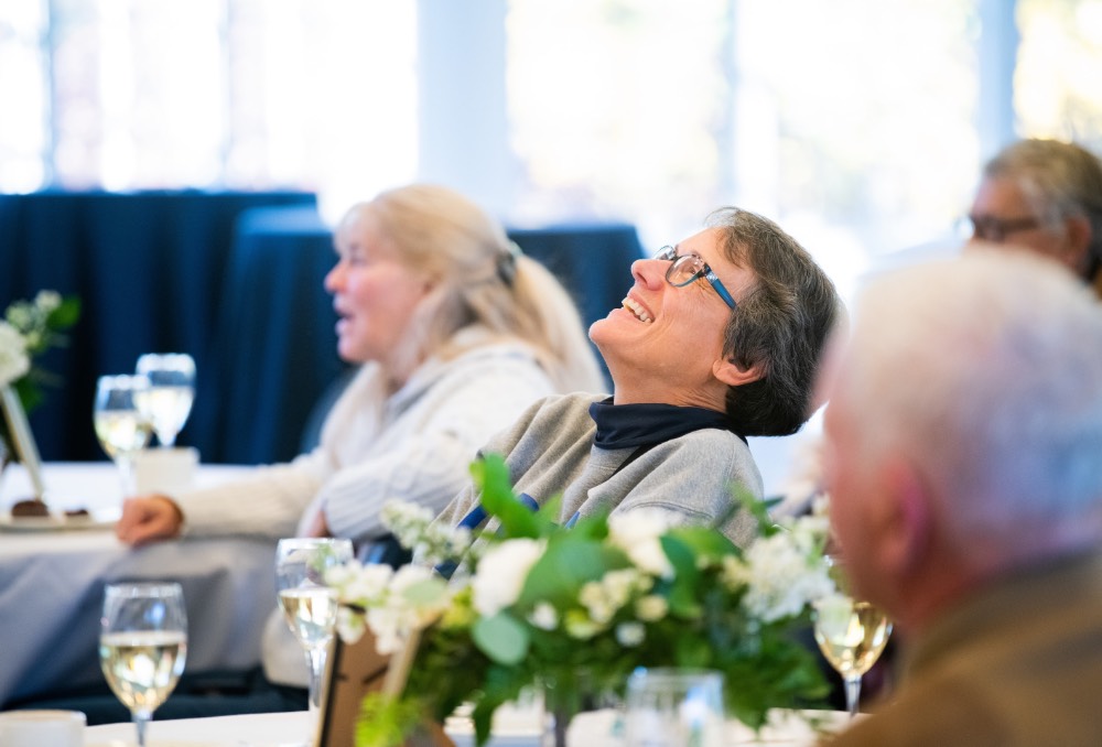 Woman throws her head back laughing